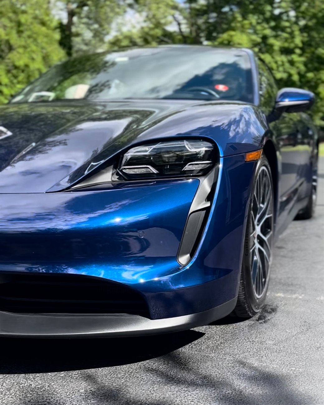 A cobalt-blue Porsche Taycan with a flawless, mirror-deep finish detailed by Detail By Design.